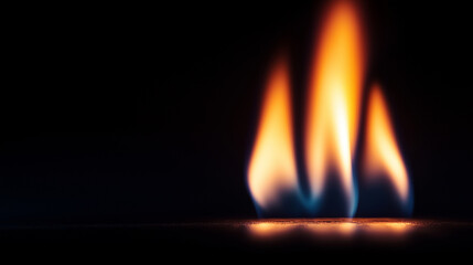 Naklejka premium slow-motion close-up of flames flickering and dancing against a pitch-black background, emphasizing the power and beauty of the fire as it burns. The flamesâ intricate details and