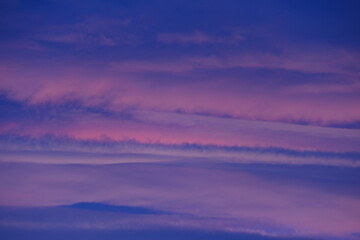 Pastel hues paint the twilight sky layers of clouds creating a serene dreamscape