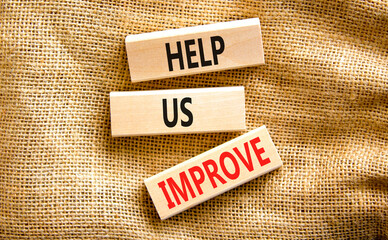 Help us improve symbol. Concept words Help us improve on beautiful wooden blocks. Beautiful canvas table canvas background. Business motivational help us improve concept. Copy space.