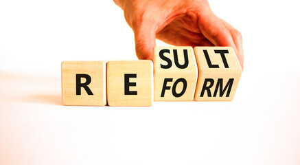 Reform and result symbol. Concept words Reform Result on beautiful wooden block. Beautiful white...