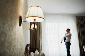 Beautiful man, groom posing and preparing for wedding