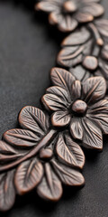 Ornate bronze floral pattern on dark textured background for decorative design