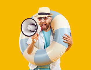 Cheerful man actively shouts into megaphone announcing interesting offers for summer vacation. Bearded man in beachwear and with inflatable swimming ring talking into loudspeaker on orange background.