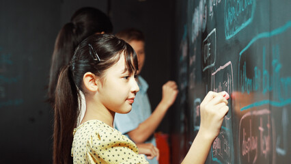 Multicultural smart student writing engineering code with site view. Diverse children planning...