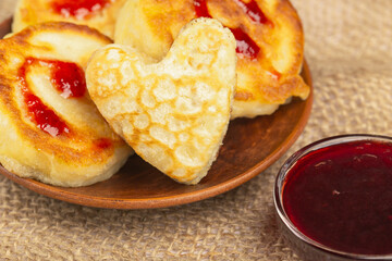 amazingly delicious pancakes on a plate and jam in a glass vase