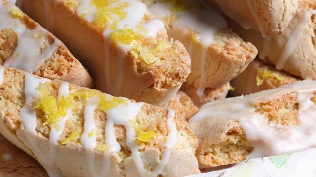 Making lemon biscotti to have with coffee.  Baking fresh lemon cookies made with ingredients like lemon, flour, sugar, eggs, vanilla and topped with a lemon glaze.