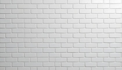 Obraz premium A close-up view of a white brick wall. The bricks are arranged in a regular pattern, creating a textured surface. The bricks are uniformly white, showing the rectangular shapes and mortar lines. 