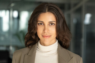 Closeup headshot face portrait of beautiful successful hispanic young business woman looking...