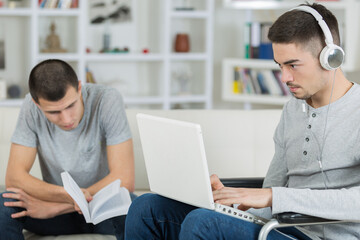 two young men relaxing one in wheelchair