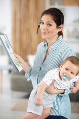 businesswoman mother woman with a toddler working from home