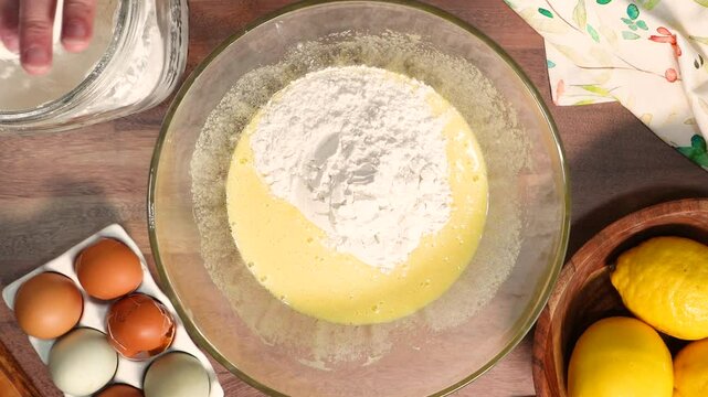 Making lemon biscotti to have with coffee.  Baking fresh lemon cookies made with ingredients like lemon, flour, sugar, eggs, vanilla and topped with a lemon glaze.