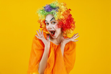 Cute girl dressed like clown on yellow background. Surprise party