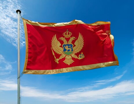 Montenegro flag waving in the wind on a blue sky background