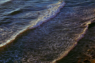 Photos of sea waves moving at sunset