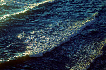 Photos of sea waves moving at sunset