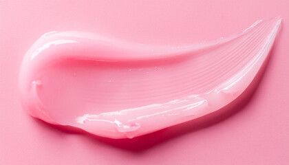 Pink smooth texture of gel or cream smear on pastel pink backdrop. Moisturizing and skin care