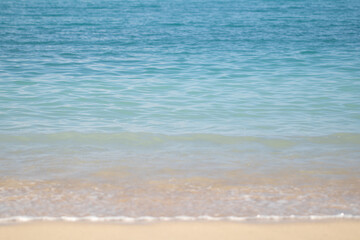 A breathtaking view of the deep blue ocean water, stretching endlessly towards the horizon. The crystal-clear water reflects the sky, creating a vibrant and serene scene with gentle ripples on the sur