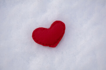 Fototapeta premium Love is in the air.Valentines Day handcrafted heart in winter in the snow from above.S pace for text