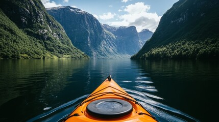 A person kayaking on a serene lake with mountains in the distance, capturing the adventure and tranquility of outdoor water sports.