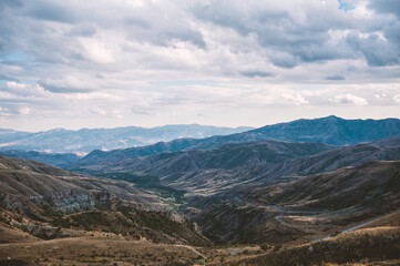 Naklejka premium Majestic mountains of Armenia under a blue sky filled with clouds