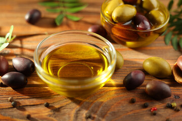 A premium olive oil with olives and fresh leaves, top view 