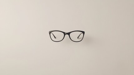Black framed eyeglasses on a beige background
