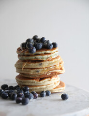 Stack of blueberry pancakes with honey drizzle