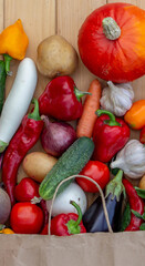 Fresh Organic Vegetables in Paper Bag on Wooden Background