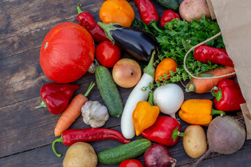 Fresh Organic Vegetables in Paper Bag on Wooden Background