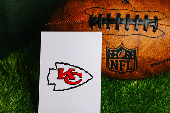 Kansas City Chiefs NFL team Logo and American football ball on Green Grass. Chiefs are participants in Super Bowl LIX for season 2024