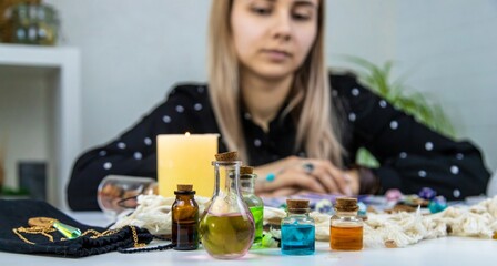 Woman fortune teller prepares a potion. Selective focus.