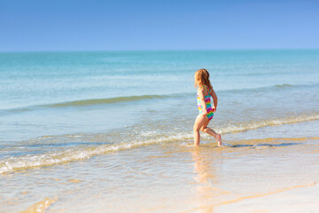 Kids playing on beach. Children play at sea.
