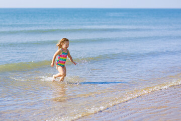 Fototapeta premium Kids playing on beach. Children play at sea.