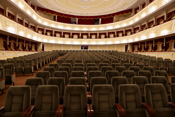 Rows of gray comfortable seats in theatre