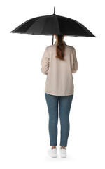 Young woman with black umbrella on white background, back view