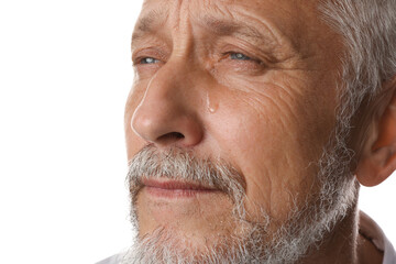 Sad senior man crying on white background, closeup