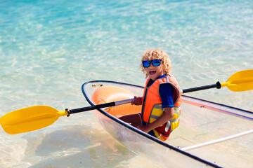 Kids kayaking in ocean. Family in kayak in tropical sea