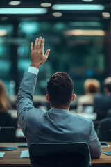 A businessman raising his hand to ask a question in a corporate meeting setting