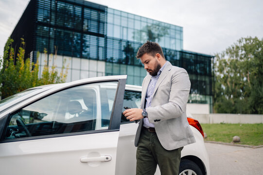Businessman opening car door with car keys
