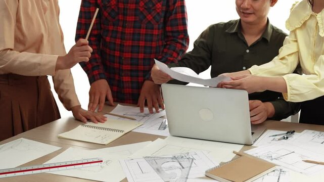 Architect and safety engineer celebrate success design building blueprint project on laptop with architectural document and measurement tool scatter around at modern office. Closeup. Delineation.