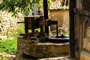 Ancient Nut Press A historical nut oil press in a rustic village setting