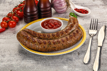 Grilled beef sausages with sauce