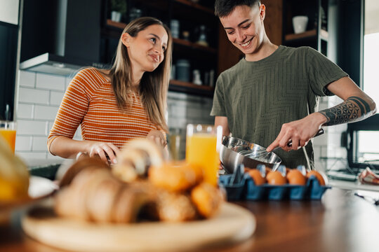 Two lesbian lgbt women preparing breakfast in modern kitchen - Powered by Adobe