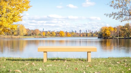 Obraz premium Autumn park bench by lake, city skyline view, relaxing scene