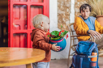 Father and his son tourists in a colonial house in San Cristobal de las Casas, Mexico. Cultural exploration, architecture, and travel experience concept