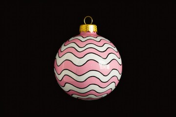A pink and white Christmas ornament with a wavy pattern.