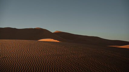 Windswept sand dunes creating a beautiful wavy pattern in sahara desert near merzouga in morocco