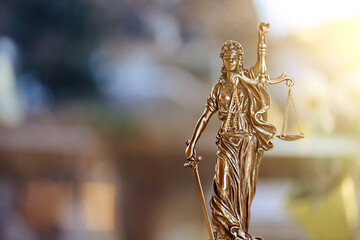 Fototapeta premium The Statue of Justice on defocused background. Selective focus