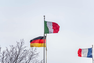 The flags of Italy, Germany, and France.