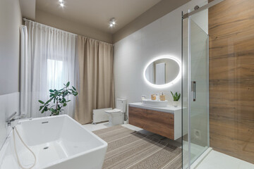 Exclusive bathroom interior. A window with curtains, a carpet on the floor, a pot with a green plant.